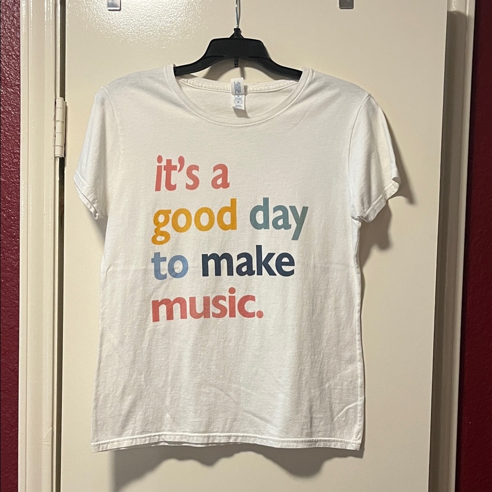 Delta Soft White Tee with Multicolor Text “It’s a good day to make music.”